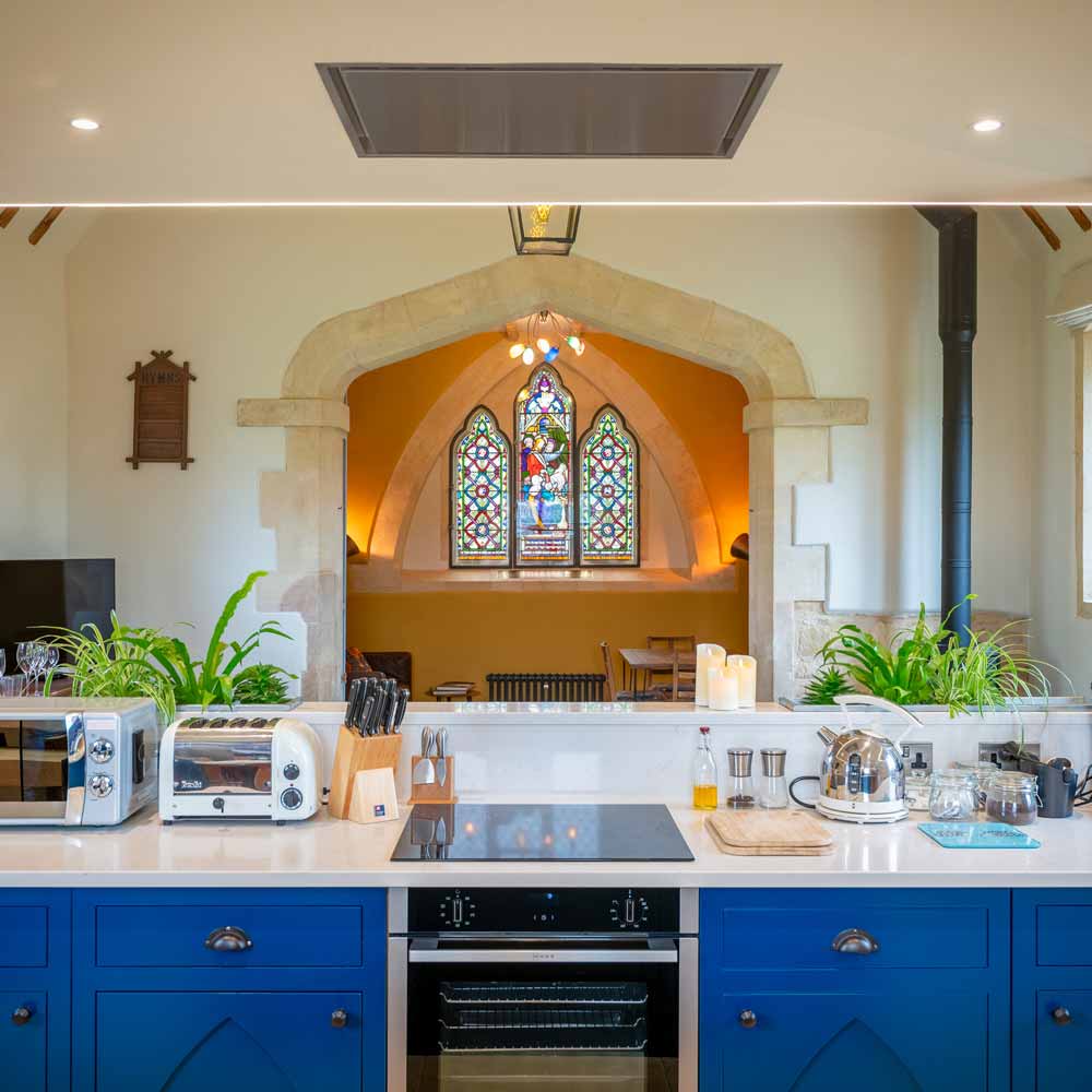 Open plan kitchen with a stained glass window feature