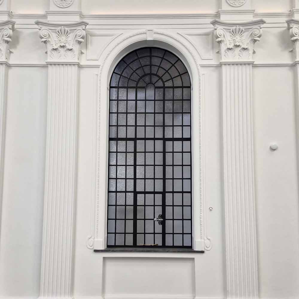 External view of a large replacement metal window within a listed building