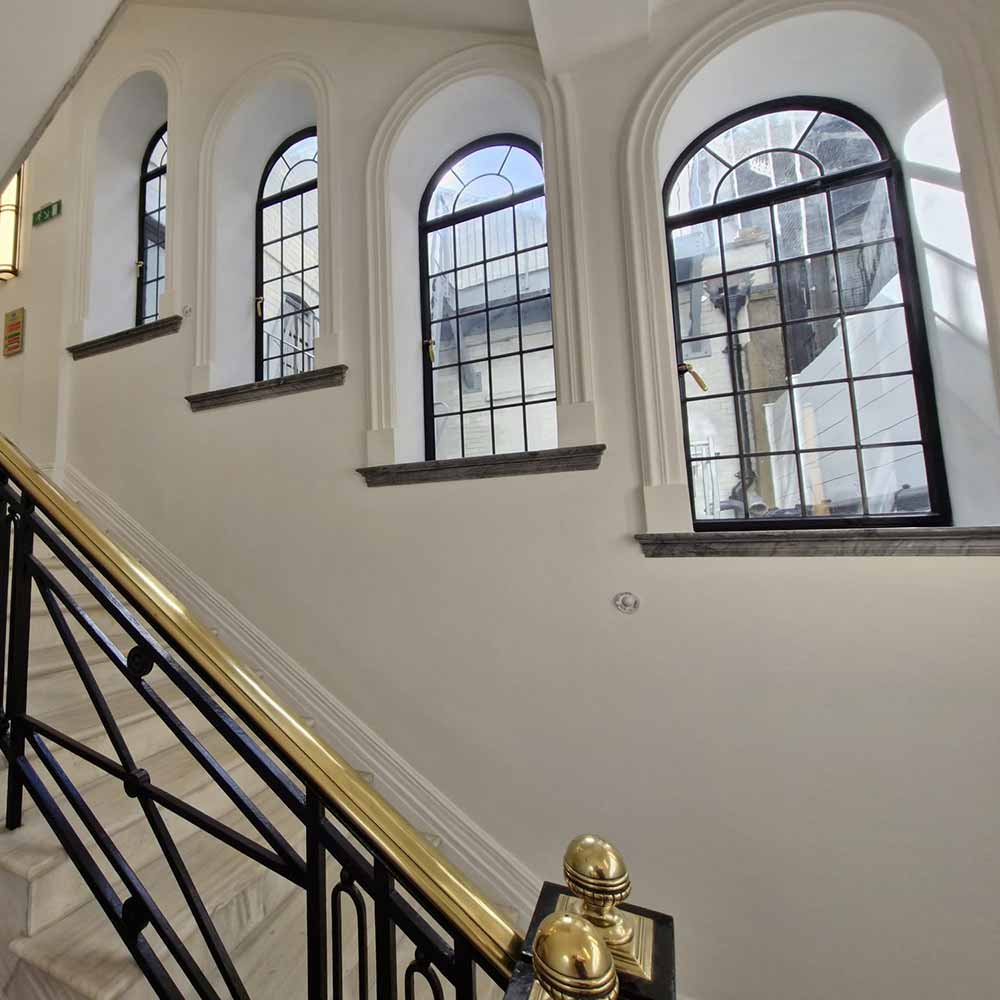 Four restored historic metal windows in a listed London building