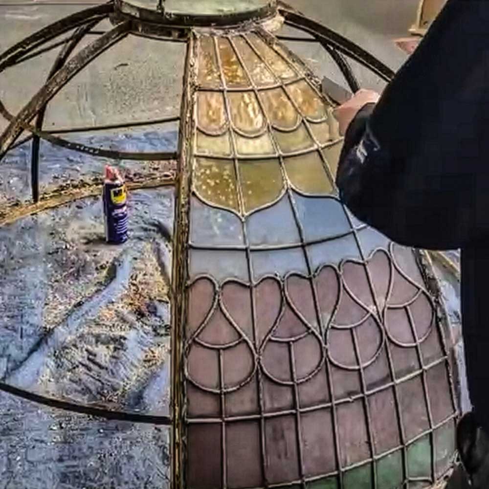 Close-up view of the stained glass dome panels being removed for repair in the Hawkscroft workshop