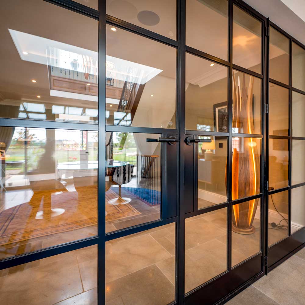 Close-up view of black metal internal glazed doors with bar handles